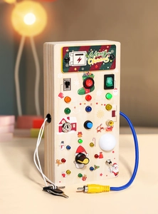 Close-up of wooden Christmas busy board with colorful LED lights and mechanical switches