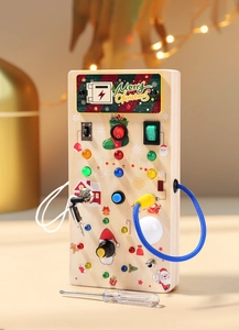 Close-up of Montessori wooden busy board with LED lights and Christmas design for toddlers