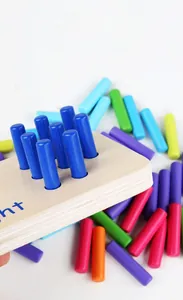 Detail view of colorful wooden pegs and perforated base for Montessori math learning