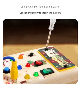 Detail of wooden busy board battery compartment and screwdriver operation for kids