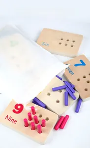 Macro shot of wooden counting boards with numeric sticks and a mesh storage bag