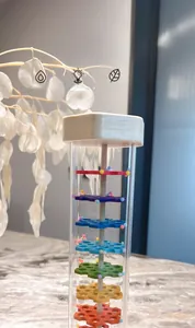 Detail of wooden rainmaker shaker with colorful beads for auditory sensory training