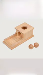 Macro detail of wooden Montessori object permanence box with smooth pine wood balls