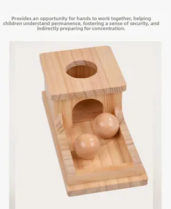 Top view of Montessori wooden object permanence box with two solid balls for motor skills