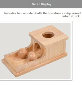 Detailed view of Montessori wooden object permanence box with two smooth solid wood balls