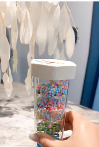 Detail showing inner colorful beads and perforated plates of the rainmaker toy