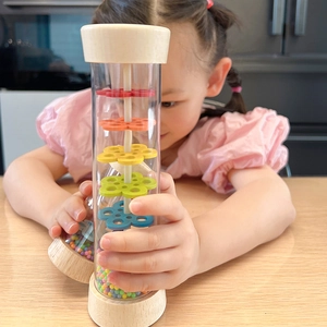 Rainbow rainmaker musical toy for toddlers featuring colorful beads and wood finish
