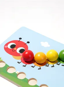 Close-up of colorful wooden beads and caterpillar puzzle board with water-based paint