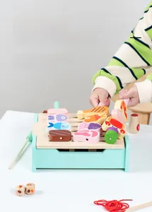 Kids wooden barbecue grill toy detail showing hand-eye coordination with food models