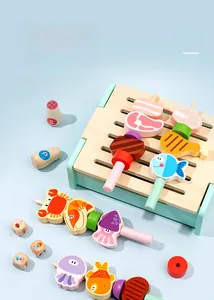 Detail of wooden toy BBQ set with mint green grill, seafood skewers and spice bottles