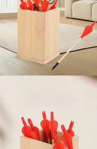 Macro detail of wooden arrows with red fletching and a square wooden storage container