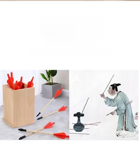 Traditional wooden pitch-pot game set with red feathered arrows and a natural wood canister