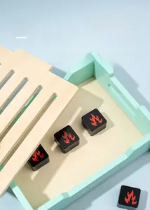 Close-up of wooden BBQ toy grill set with mint green tray and charcoal blocks