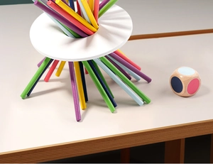 Close-up of colorful wooden balance stacking game sticks with a ring and dice for kids
