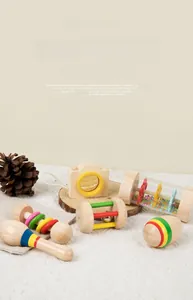 Close-up of wooden baby rattles including sand hammer and camera shape for sensory play