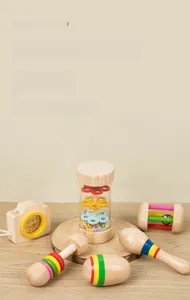 Detail of wooden montessori baby rattle set with rainbow shaker and sensory rainmaker toy