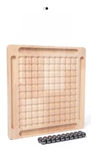 Close-up of the wooden board with circular grooves and magnetic beads for strategy game