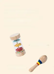 Detail of wooden rainmaker and maraca rattle for infant musical rhythm training
