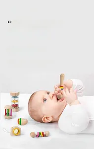 Macro detail of baby holding a colorful wooden rattle made of safe eco-friendly materials
