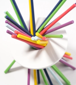 Macro view of colorful wooden sensor sticks inserted in a round white base for kids
