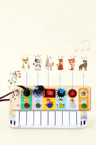 Detail of wooden sensory busy board with colorful piano keys and interactive animal sound buttons