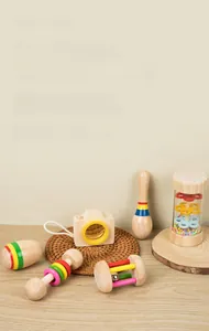 Close-up of polished Montessori wooden baby rattles and musical instruments on a mat