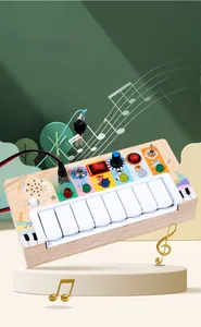 Detail of wooden busy board with piano keys, LED lights and functional switch buttons