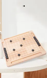 Close-up of magnetic battle chess with black spherical stones on a wooden grid board