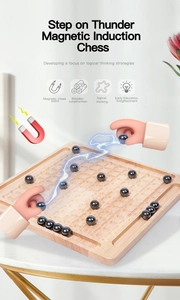 Close-up of wooden magnetic chess board with spherical black magnets for logic training