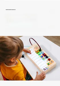 Detail of wooden busy board with LED light switches and piano keys for toddler fine motor skills