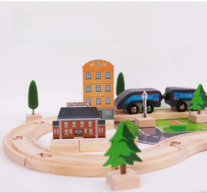Detail of wooden train track set with locomotive, buildings and scenic layout