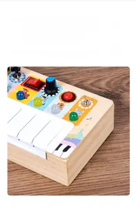 Detail view of wooden busy board with switches, LED buttons and cute animal illustrations