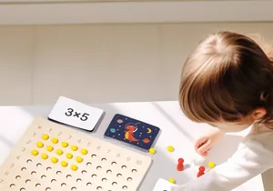 Close-up of child using wooden Montessori multiplication board with beads and equation cards