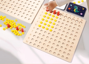 Close-up of child using wooden Montessori multiplication and division board set