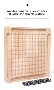 Close-up of wooden board game with round grooves and polished magnetic metal spheres