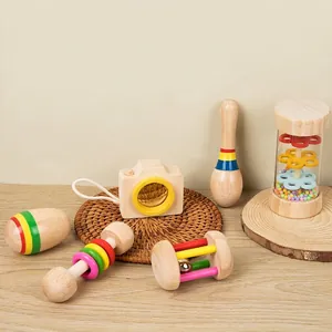 6-piece Montessori wooden baby rattle set with colorful teething toys on a rustic wooden desk
