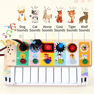 Montessori wooden busy board with switches, LED lights, piano keys and animal motifs