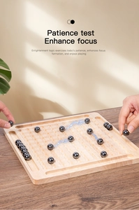 Macro shot of magnetic logic game showing polished black stones on a grooved wooden board