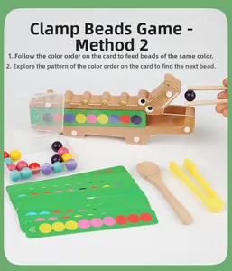 Toddler using wooden chopsticks to clip colored beads on a crocodile game board