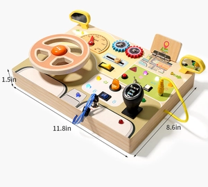 Detail view of wooden busy board with steering wheel, LED lights, and gear shift features