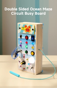 Detailed macro view of ocean-themed wooden busy board with interactive LED switches and key lock