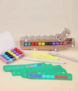 Macro shot of wooden crocodile base and colorful beads for toddler motor skills training