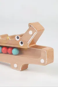 Detail view of wooden crocodile toy with colorful beads and transparent window
