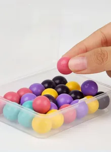 Detail showing hand-picking colorful wooden beads from a transparent storage box