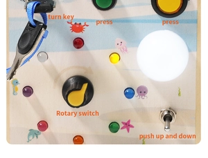 Macro detail of wooden busy board with LED lights, rotary switch, and toggle buttons