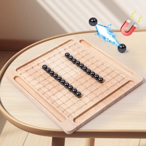Magnetic chess board game with wooden grid and black sphere pieces for family interaction