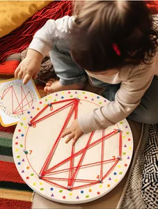 Toddler hands threading red cotton string on a round wooden Montessori geometry board