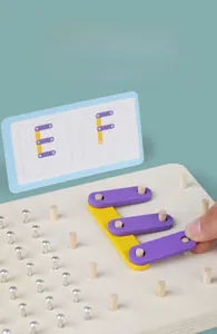 Detail of wooden pegboard with colorful blocks for letters E and F STEM learning
