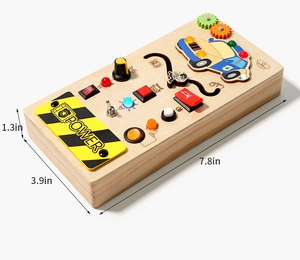 Detail view of wooden busy board toy with colorful LED lights, switches and knobs for kids