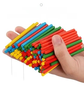 Close-up of hand holding colorful solid wood counting sticks with eco-friendly water paint